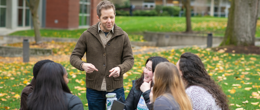 Professor of Psychology and Biology Baine Craft talks  with a few of his students from the first cohort of the Master of Science in Research Psychology program.